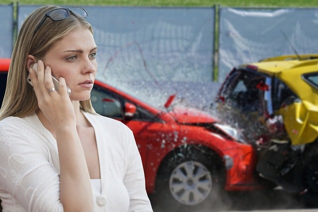 auto accident lawyers - car crash with 2 cars and a young woman on the phone